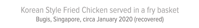 Korean Style Fried Chicken served in a fry basket Bugis, Singapore, circa January 2020 (recovered)